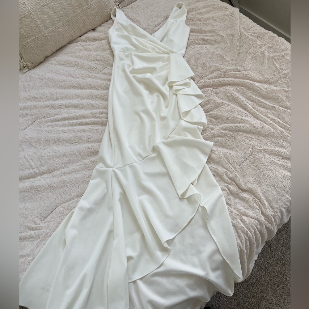 Creamy white full length dress with side split and ruffles